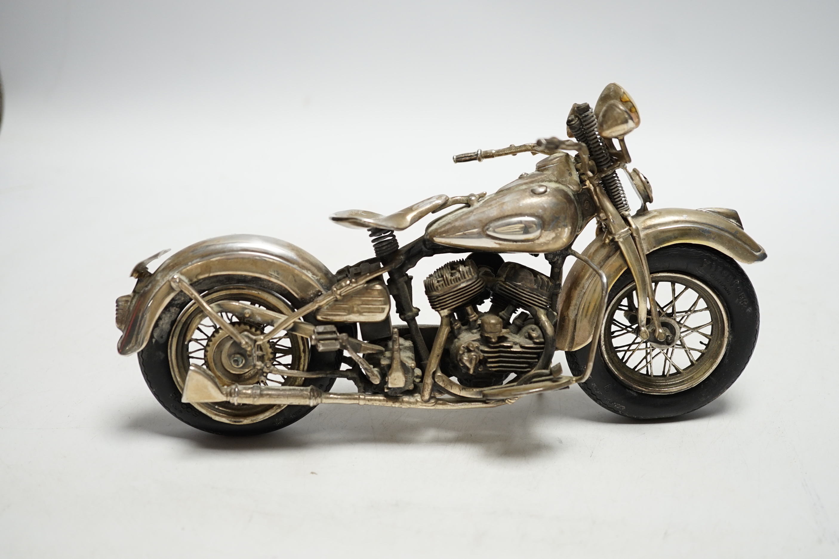 A late 1990's part silver miniature model of a Harley Davidson motor bike, Casa Julia International, London, 1997, length 23.3cm, gross weight 24.9oz.